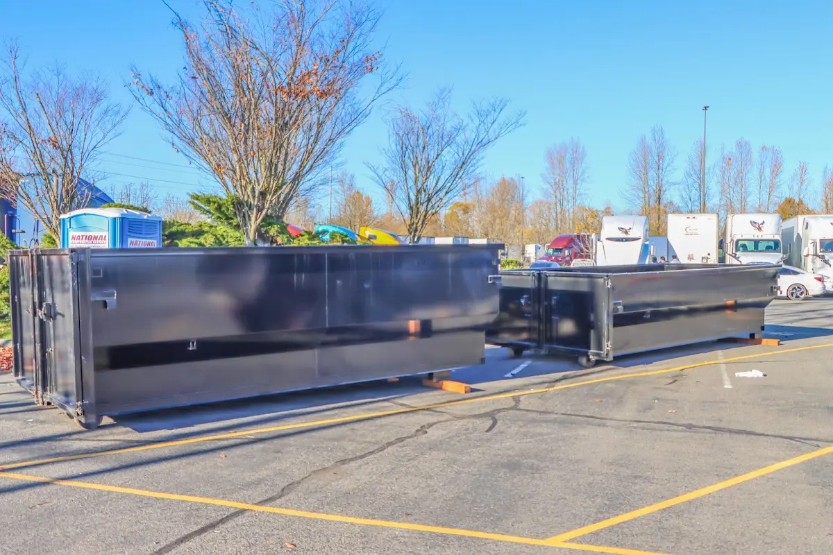 Professional dumpster rental service with roll-off container on residential driveway in Winters